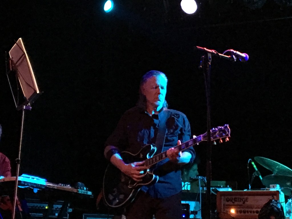Michael Gira of Swans plays guitar during his band's performance.